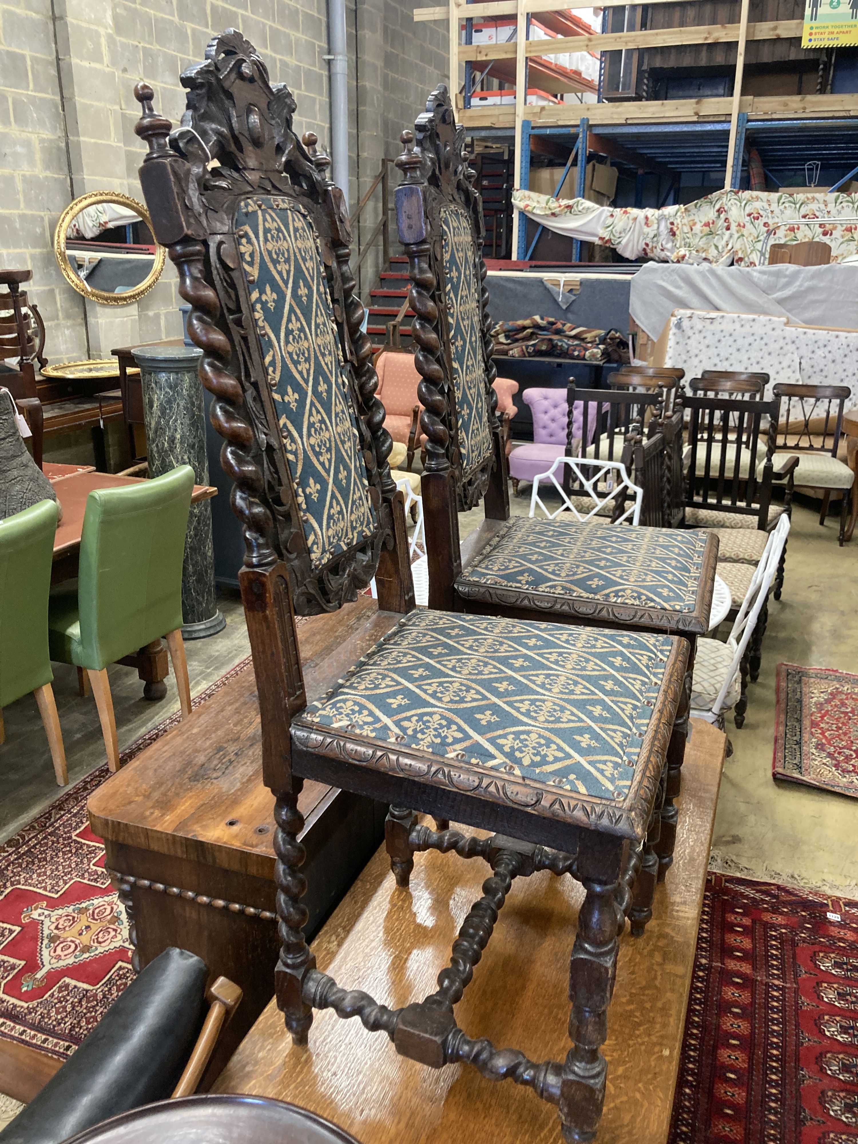 A pair of late 19th century Flemish carved oak panel backed dining chairs
